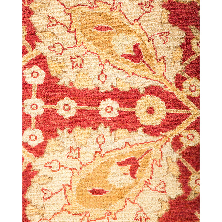 Close-up of a hand-woven rug with traditional motifs in red and cream.
