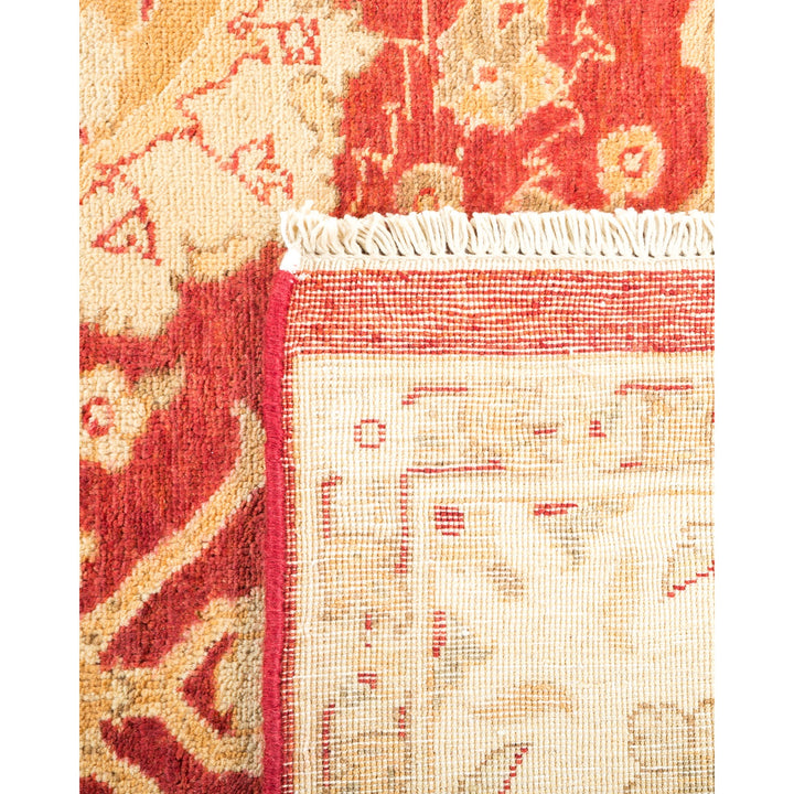 Close-up view of a intricate red and beige woven rug.