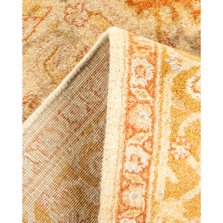 Close-up of intricately patterned rug showcasing warm tones and craftsmanship.