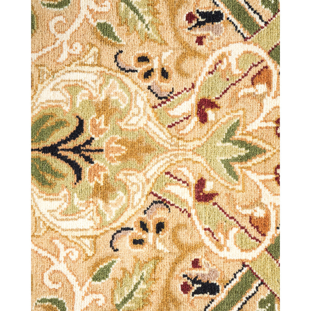 Intricate traditional carpet design with floral motifs in beige and green.