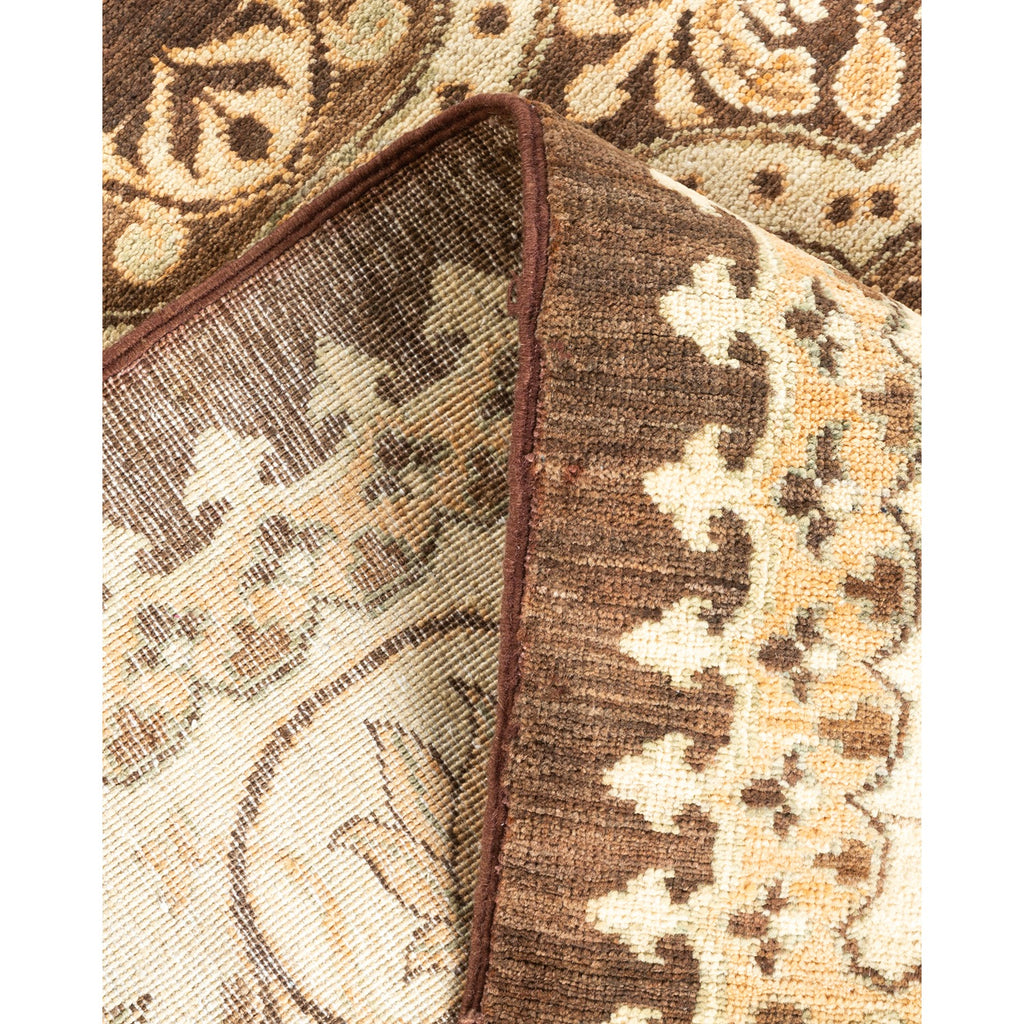 Close-up of an intricate patterned carpet with floral motifs.