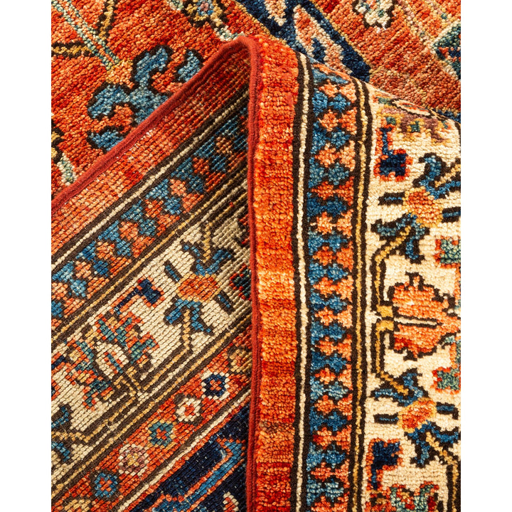 Close-up of folded Oriental rug with intricate patterns and vivid colors.