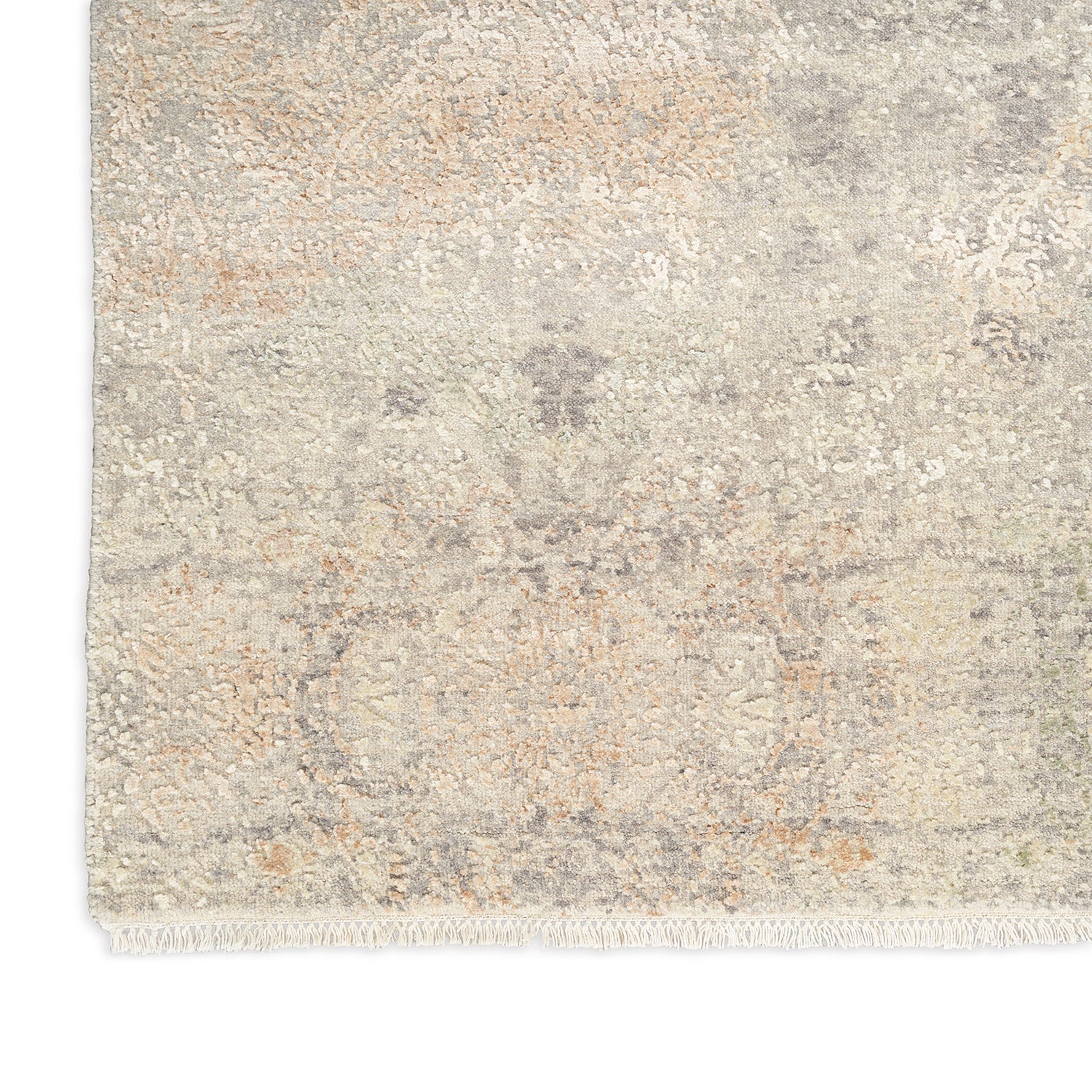 Vintage-style distressed rug with intricate floral motifs in neutral tones