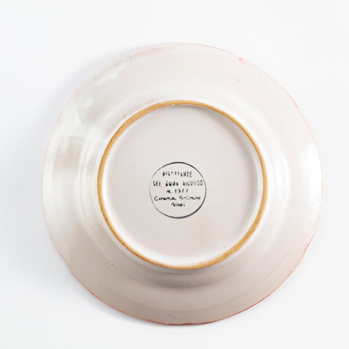 Back of ceramic plate with circular stamp indicating manufacturer and year (1971), possibly in Spanish or Italian. Golden-brown traces near rim.