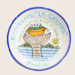 Decorative ceramic plate with Italian restaurant motif and German word.