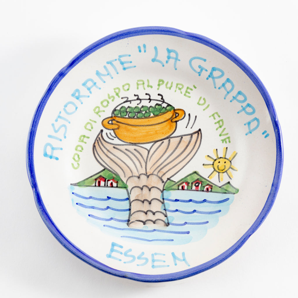 Decorative ceramic plate with Italian restaurant motif and German word.