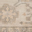 Intricate, muted textile displays floral and geometric motifs in beige.