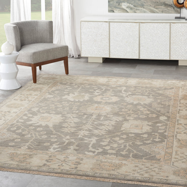 Elegantly appointed room with modern furniture and intricate area rug.