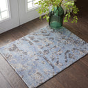Contemporary rug with distressed blue pattern complemented by natural decor.