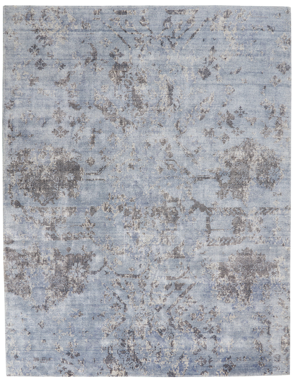 Vintage-inspired rug with distressed floral pattern adds elegance to decor.