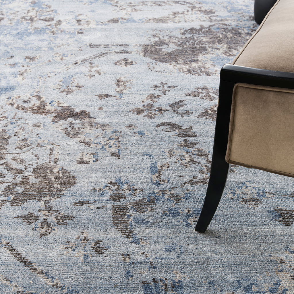 Detail of a vintage-inspired blue carpet with modern furniture.