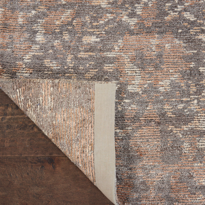 Close-up of a textured rug with intricate abstract pattern.