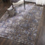 Cozy and modern interior featuring abstract area rug with distressed look.