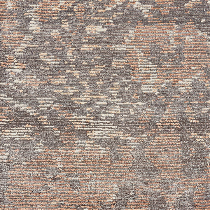 Abstract patterned carpet showing soft texture with shades of gray.