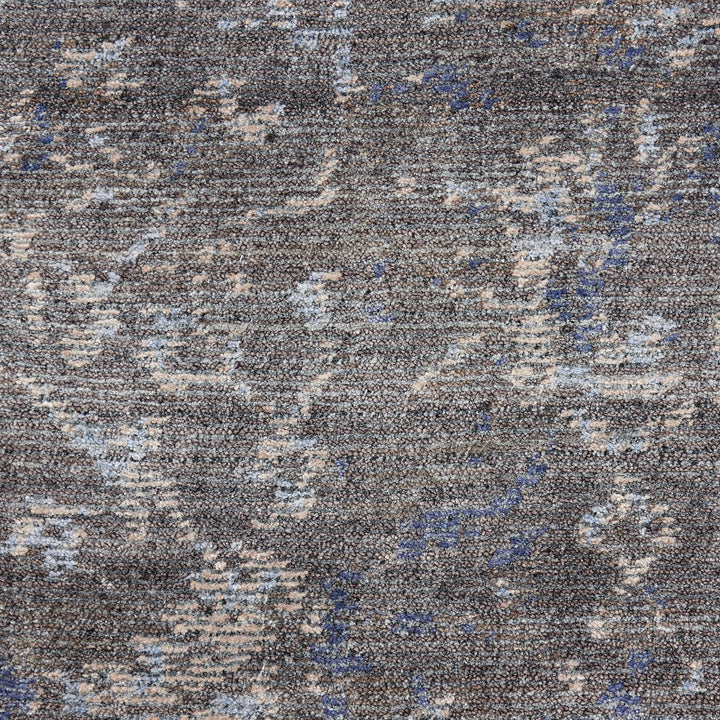 Close-up of textured carpet or upholstery with abstract pattern.