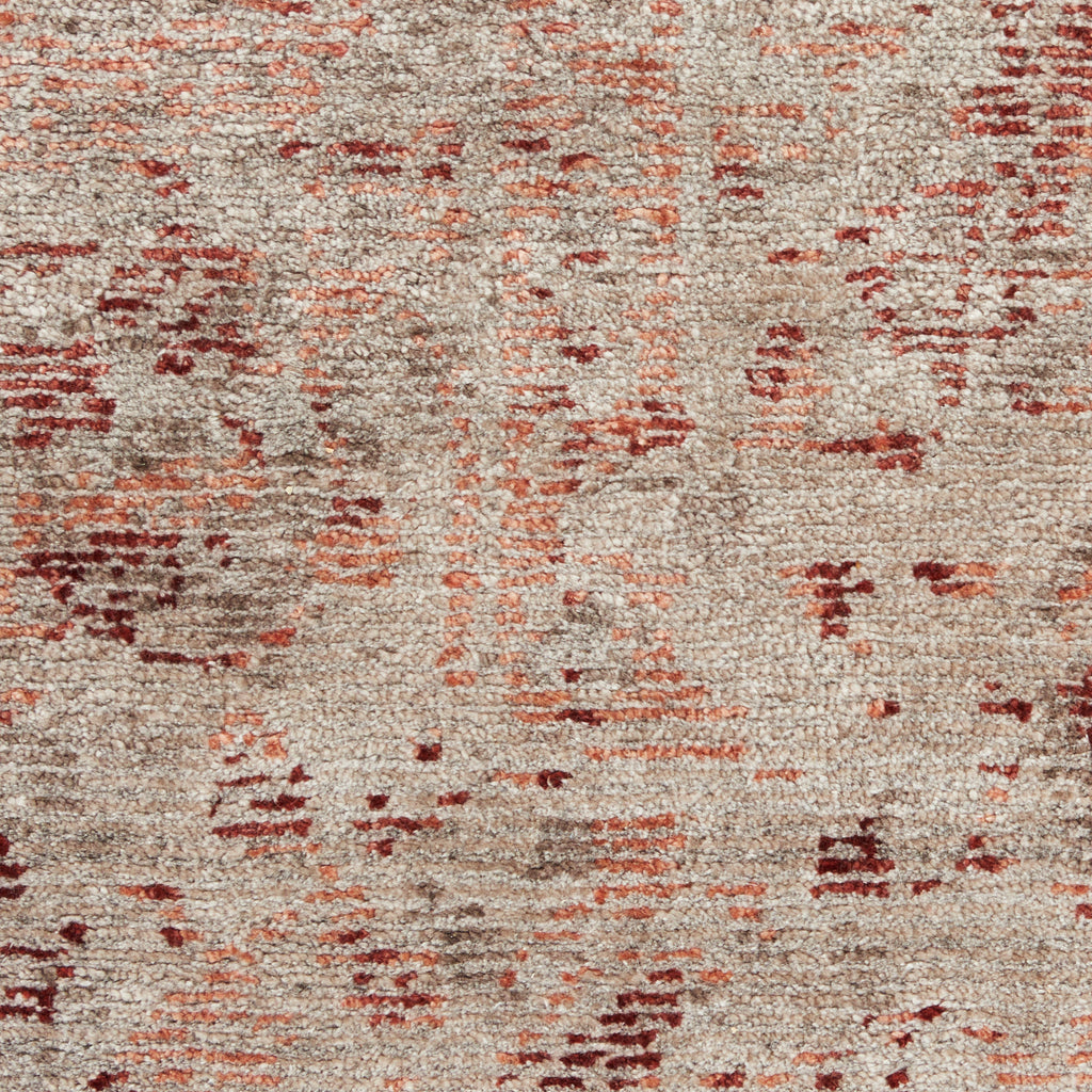 Close-up of an abstract patterned carpet with muted colors.