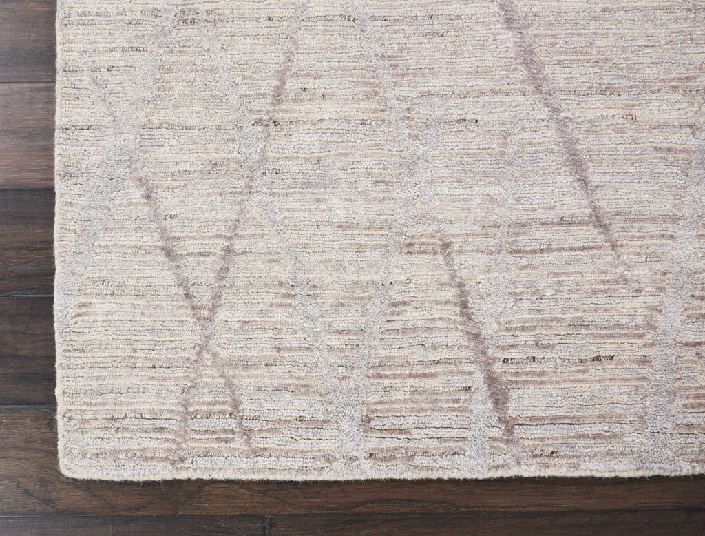 Textured beige rug adds warmth to a polished hardwood floor.