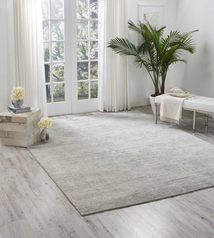 Bright and airy room with large window, white curtains, and greenery.
