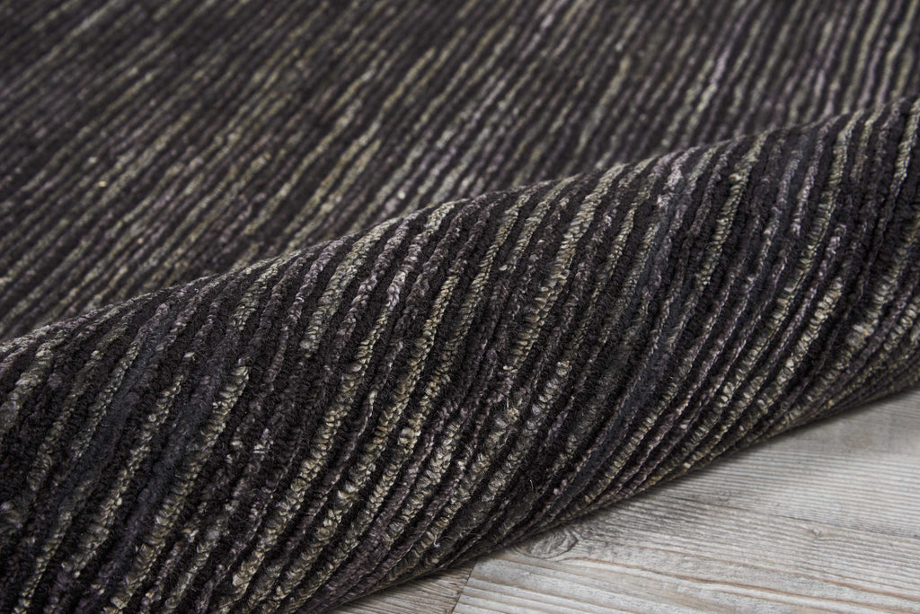 Close-up of a striped rug, with earthy shades and texture.