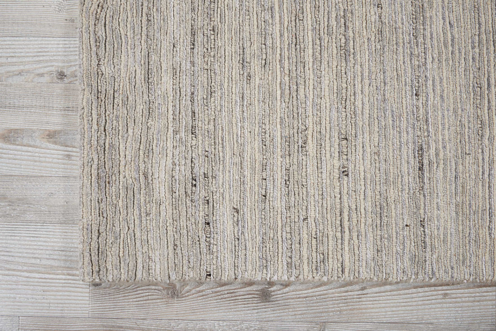 Textured fabric rug on wooden floor adds cozy rustic charm.