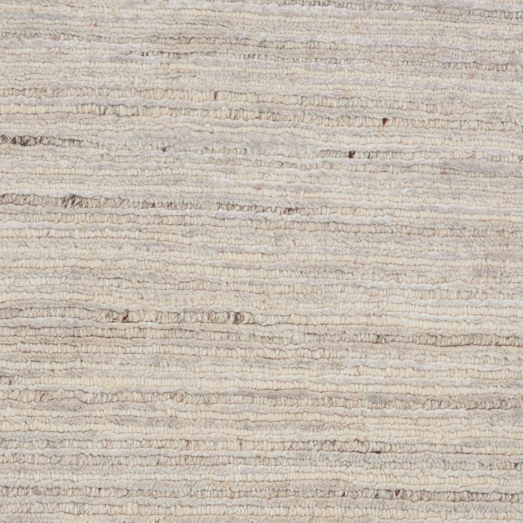 Close-up of textured, beige fabric with horizontal lines, rustic appearance.