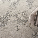 Close-up view of a textured carpet with a decorative pattern.