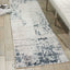 Modern abstract rug adds contemporary flair to minimalist interior design.