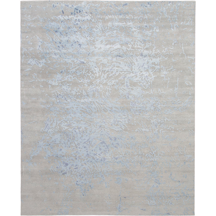 Abstract patterned rug with neutral base color adds visual interest.