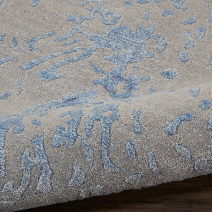 Luxurious plush carpet with abstract blue pattern creates calming ambiance.
