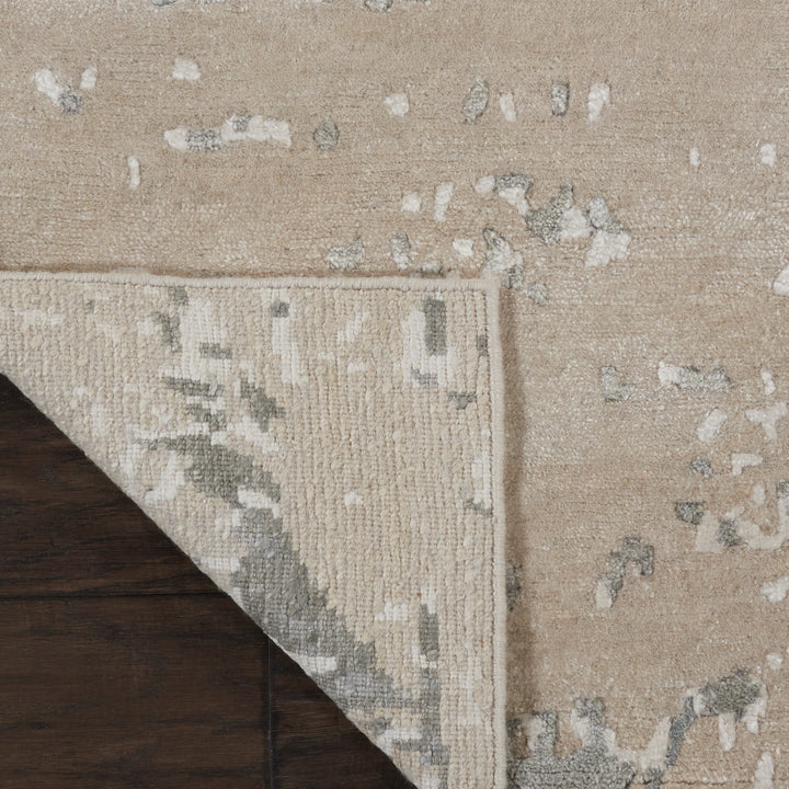 Close-up of a folded carpet corner reveals intricate pattern and texture.