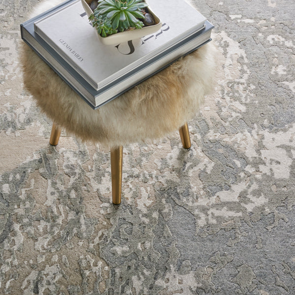 Contemporary interior featuring textured rug, furry ottoman, and stylish decor.
