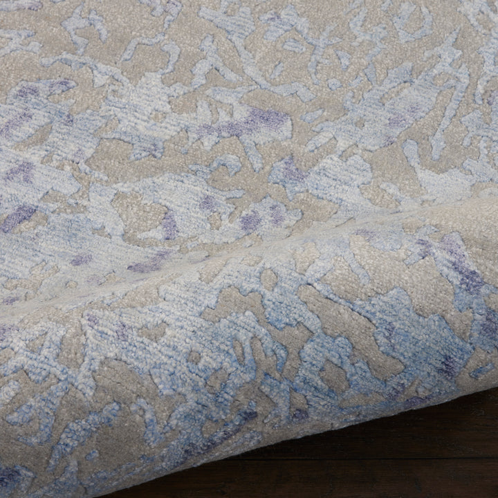 Upscale and modern blue patterned rug with plush pile texture.