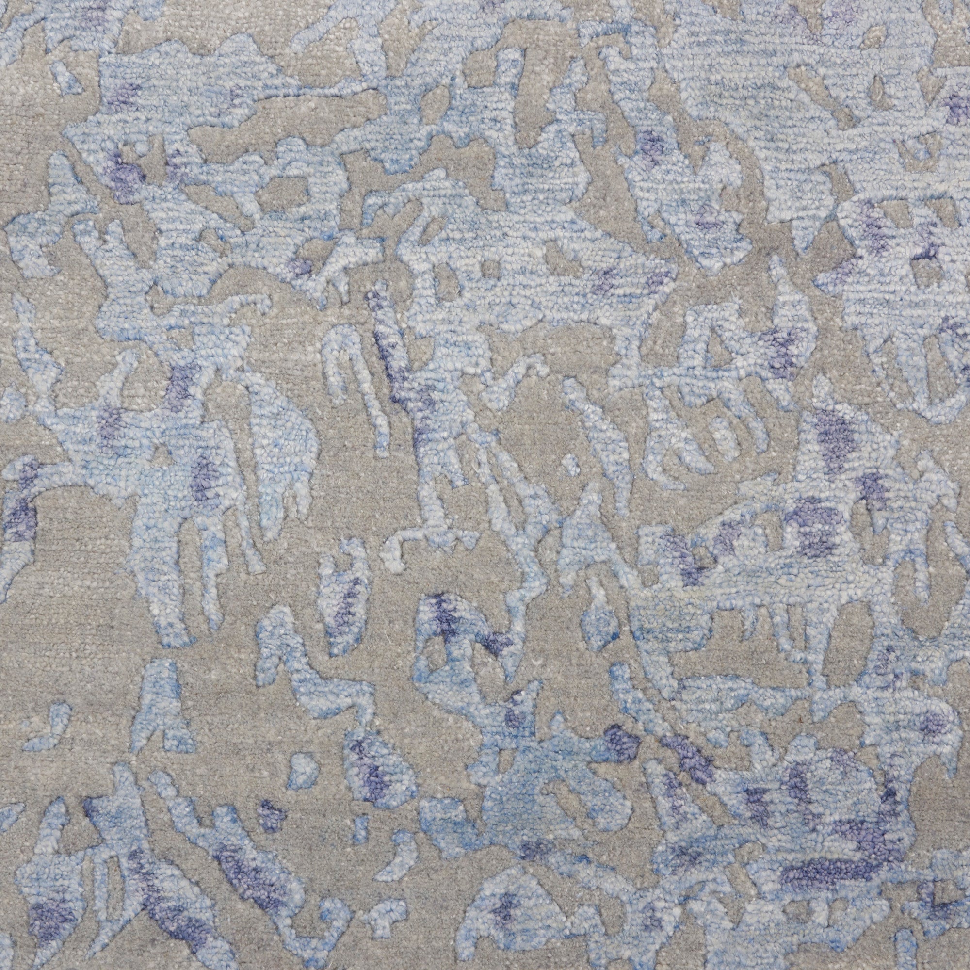 Close-up view of a textured fabric with intricate blue patterns.