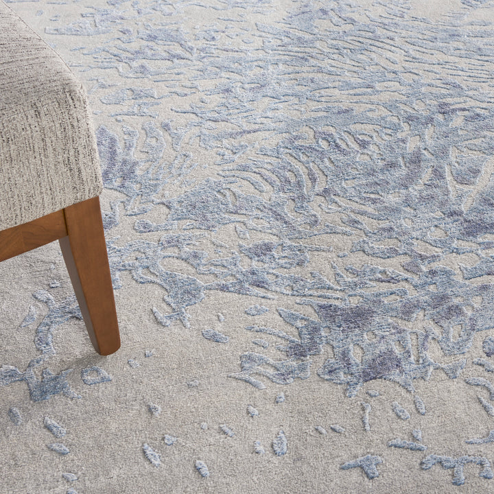 Close-up view of textured carpet and mid-century modern chair.