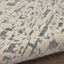 Close-up of a modern textured carpet with abstract grey design