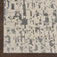 Close-up of abstract rug design in shades of grey and beige.