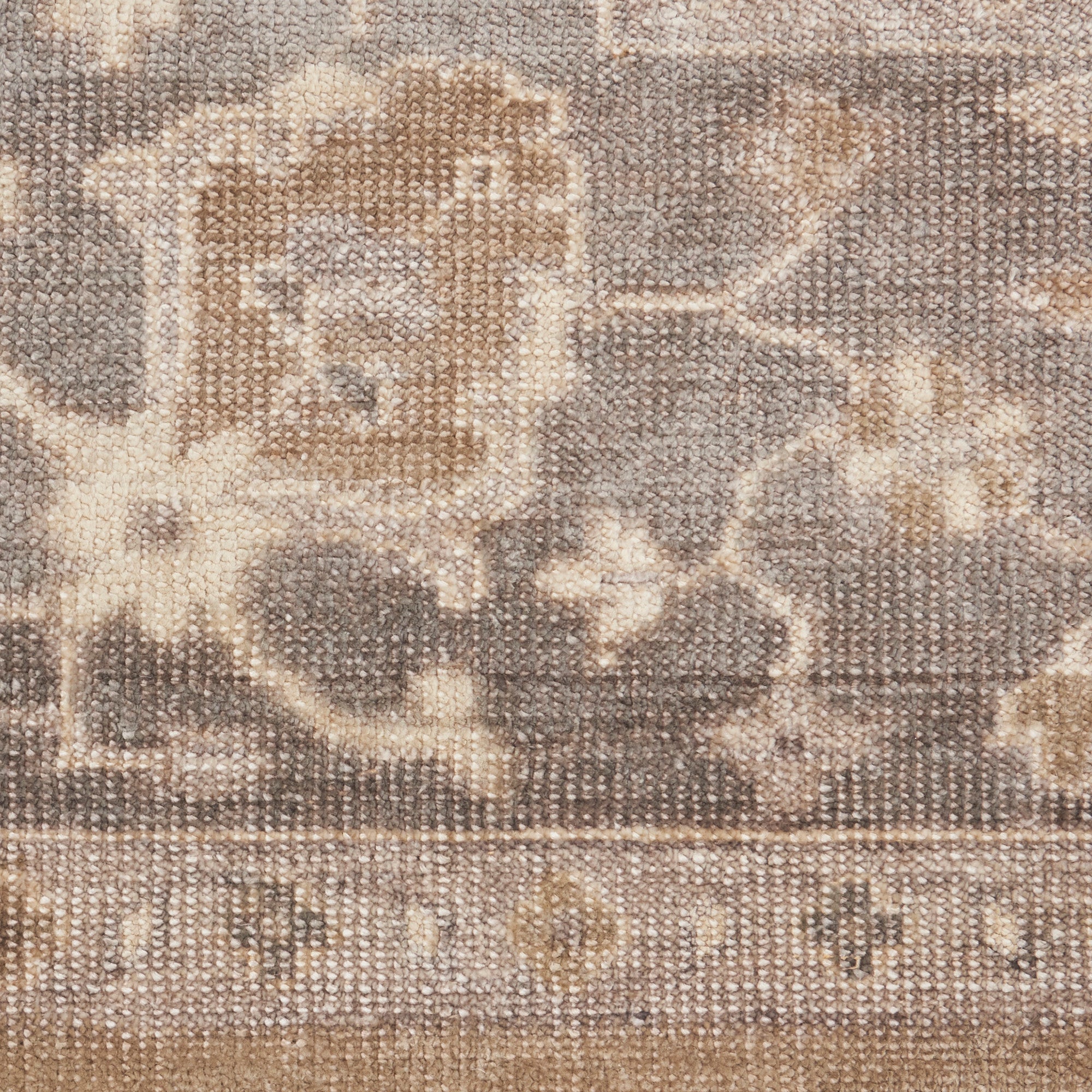 Close-up of intricately designed woven fabric with symmetrical ornamental shapes.