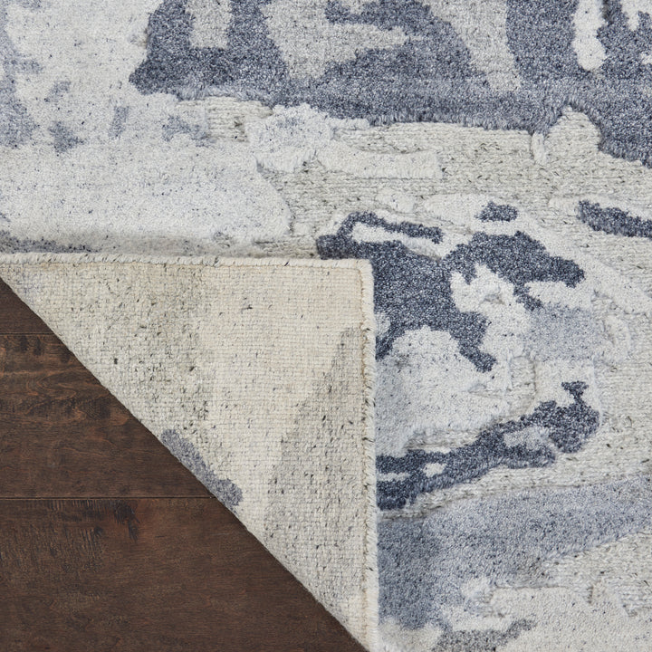 Three layers of flooring materials, showcasing hardwood, carpet, and patterned rug.