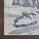 Close-up of a plush, abstract rug with blue and gray tones.