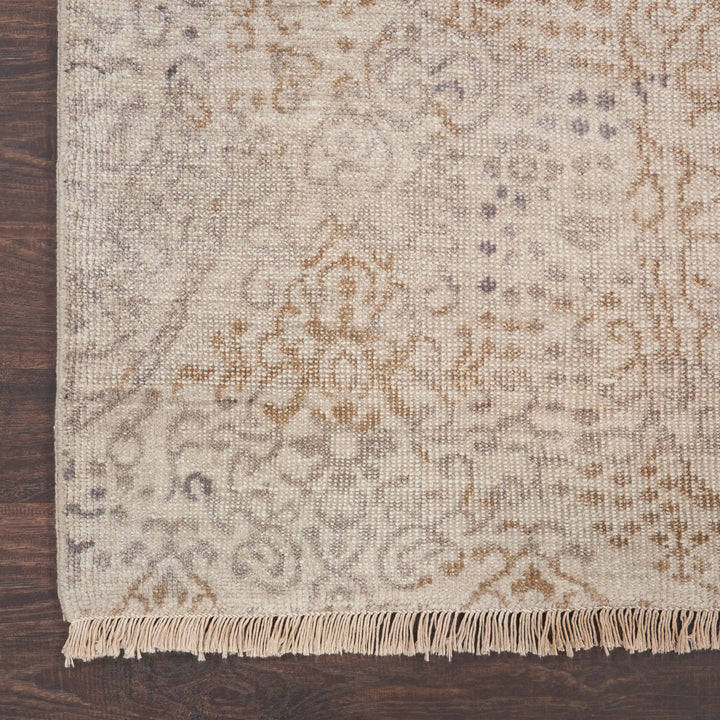 Hand-woven carpet with floral motifs adds warmth to wooden floor.