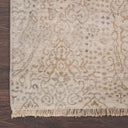 Hand-woven carpet with floral motifs adds warmth to wooden floor.