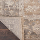 Close-up of traditional area rug on hardwood floor with vintage look.