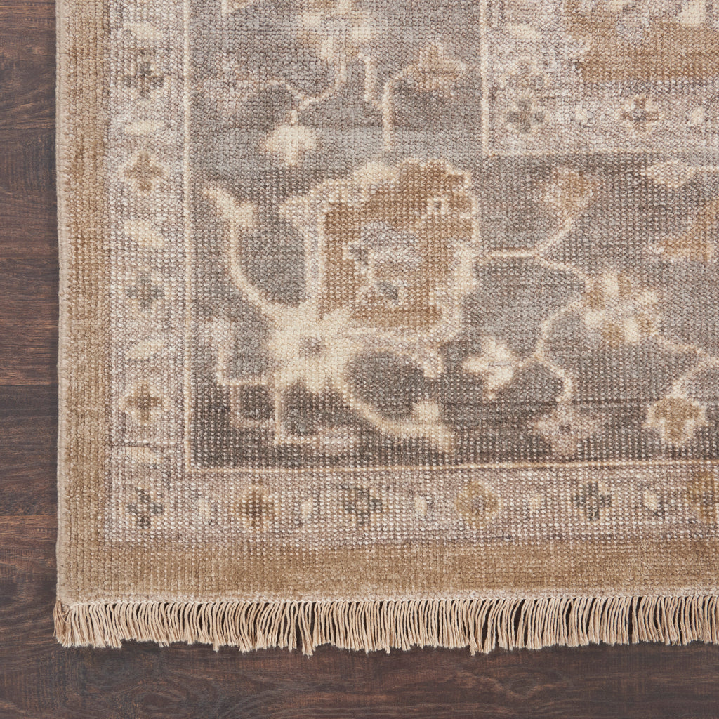 A vintage-inspired decorative rug with intricate floral motifs on hardwood.