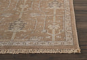 Close-up of botanical patterned rug on dark wood floor.