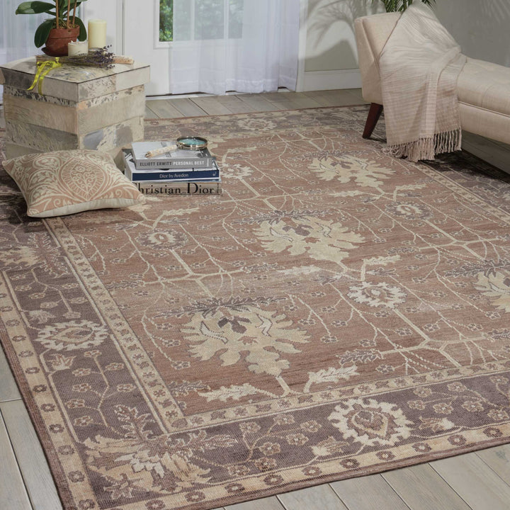 Cozy vintage-style room with floral rug, decor, and reading nook.