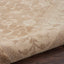 Close-up of plush, neutral area rug with subtle abstract pattern.