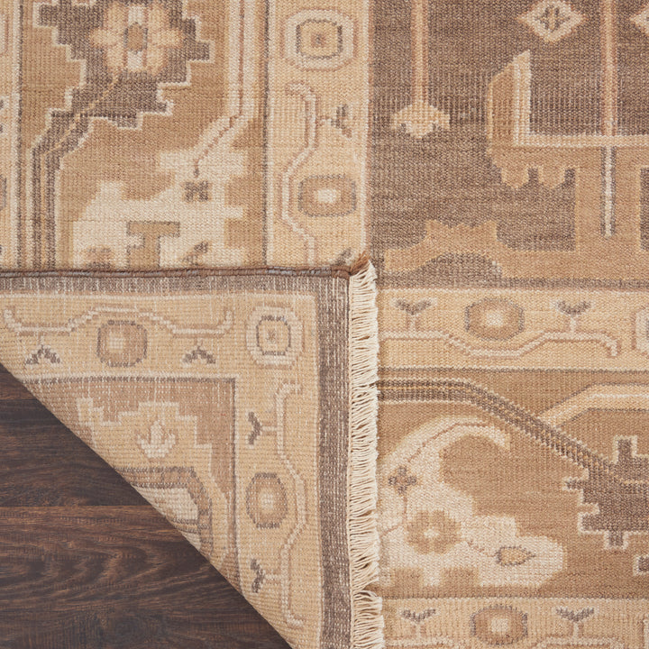 Close-up of an ornate rug with intricate geometric and floral motifs.