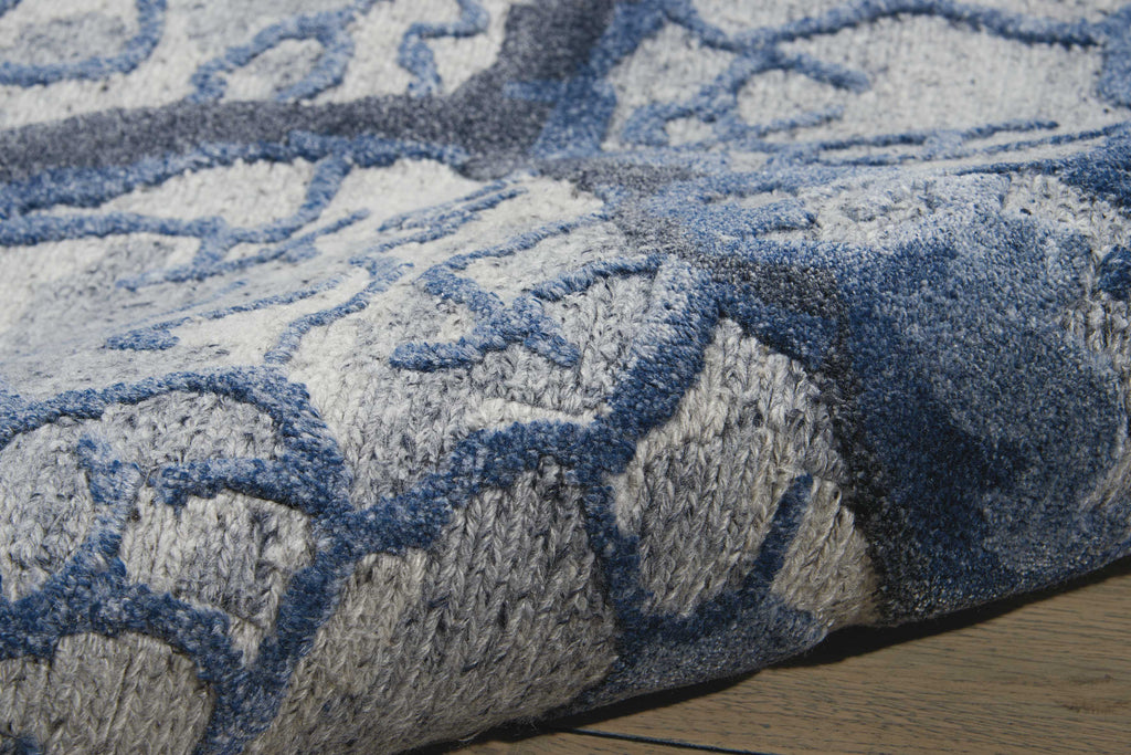 A close-up of a plush blue and grey patterned rug.