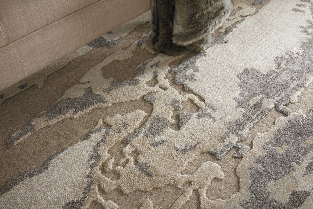 High-quality textured area rug with neutral tones complements any room.