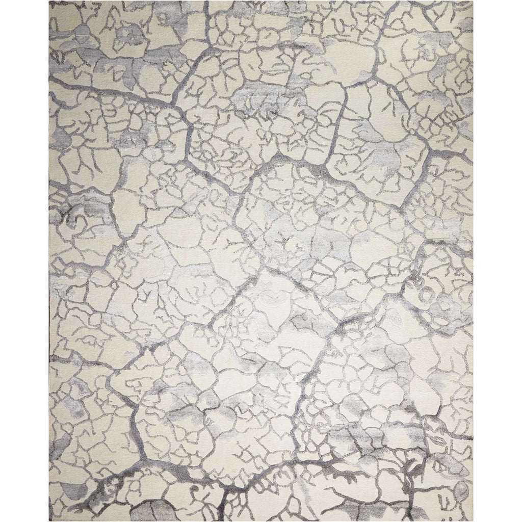 Monochromatic rug with cracked surface pattern resembles dried riverbed formations.
